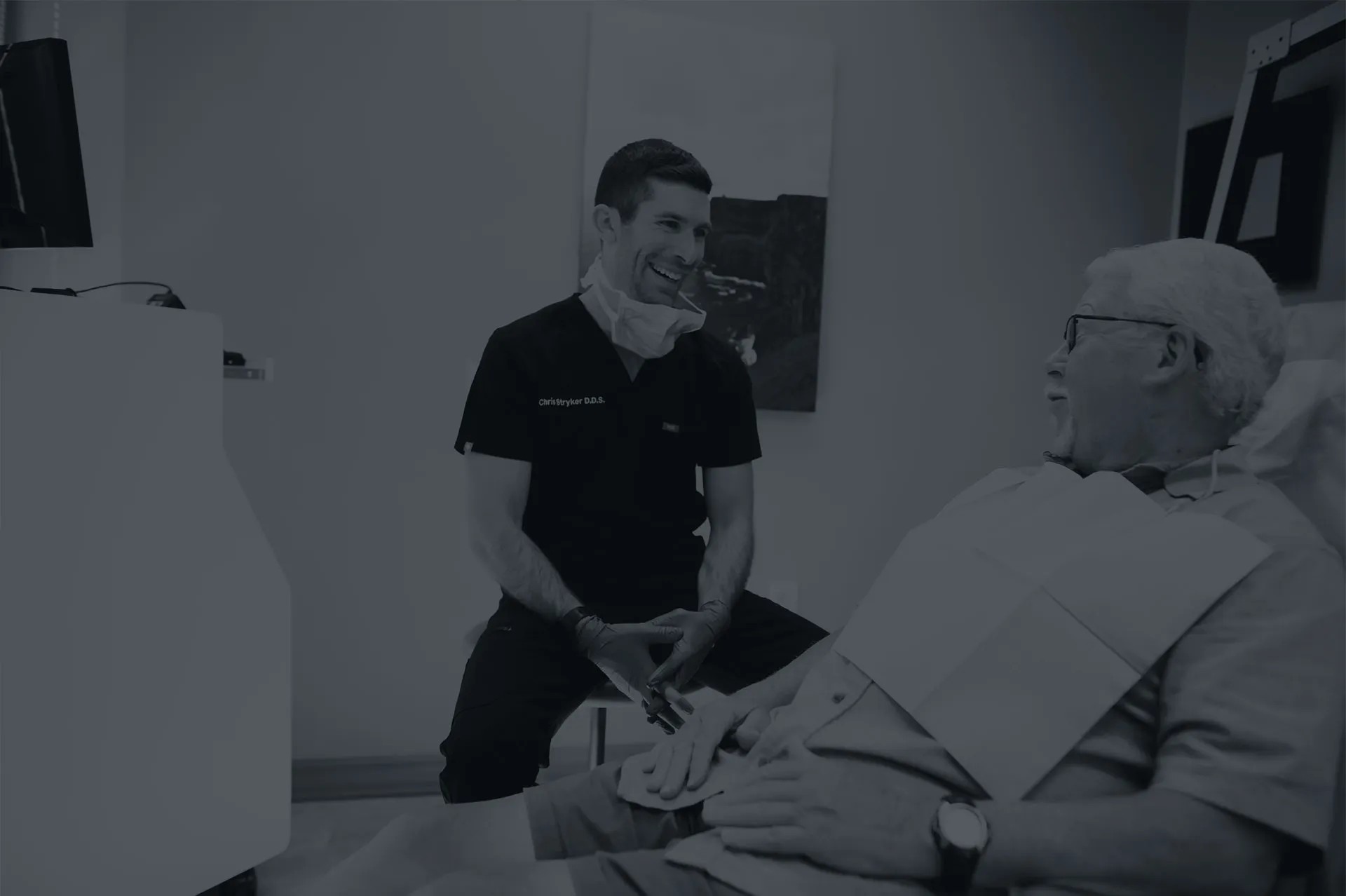 Photo of a dentist talking with a patient