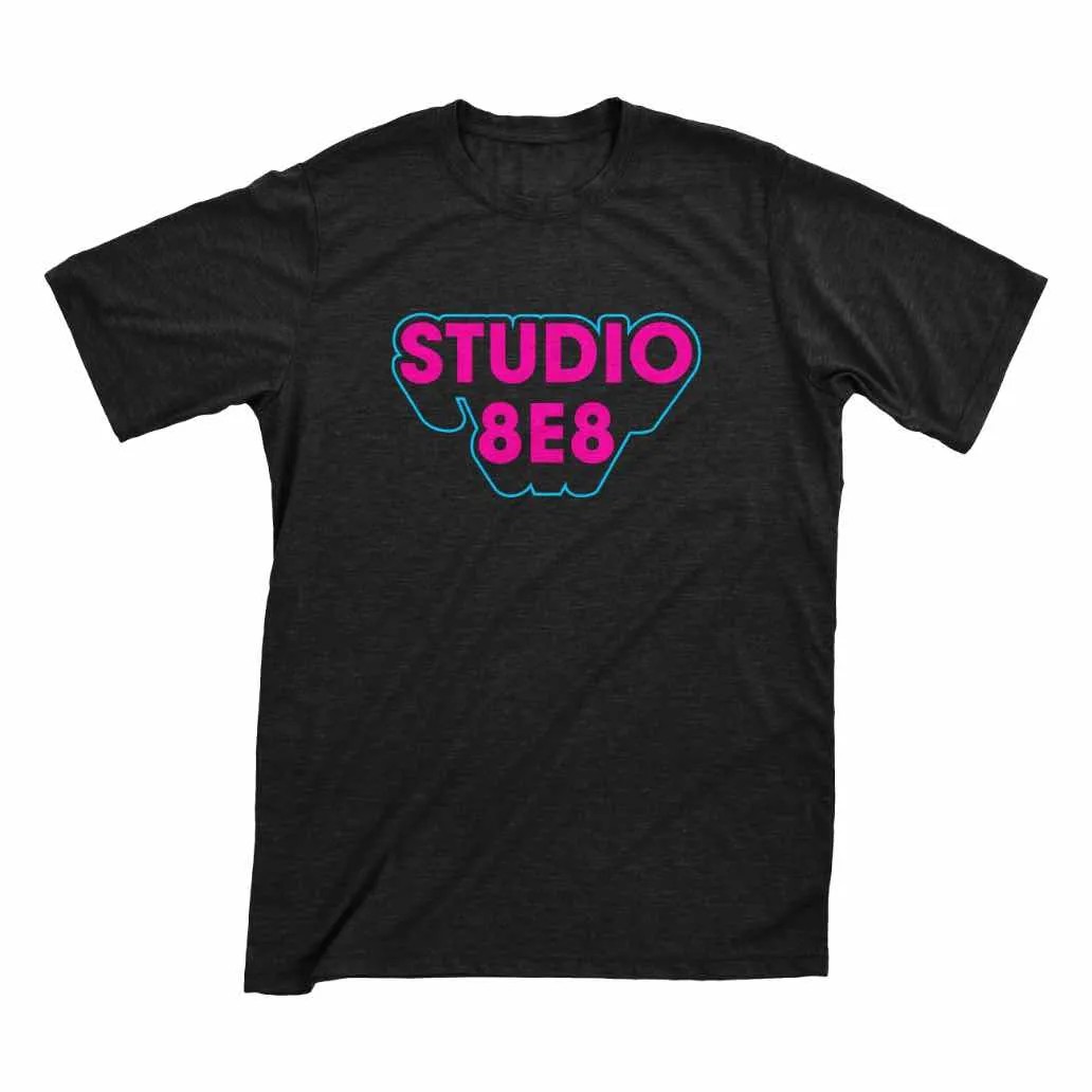 A dark gray shirt with Studio 8E8 printed on it in pink letters with a blue outline