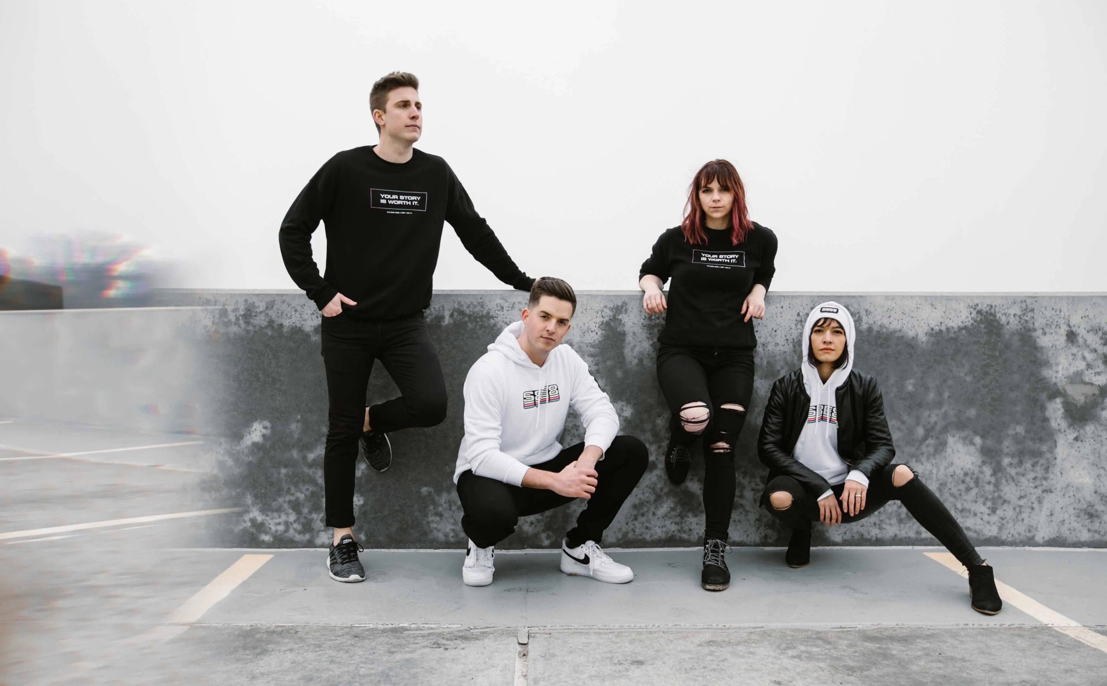 Photo of the Studio 8E8 team wearing their hoodies and sweatshirts