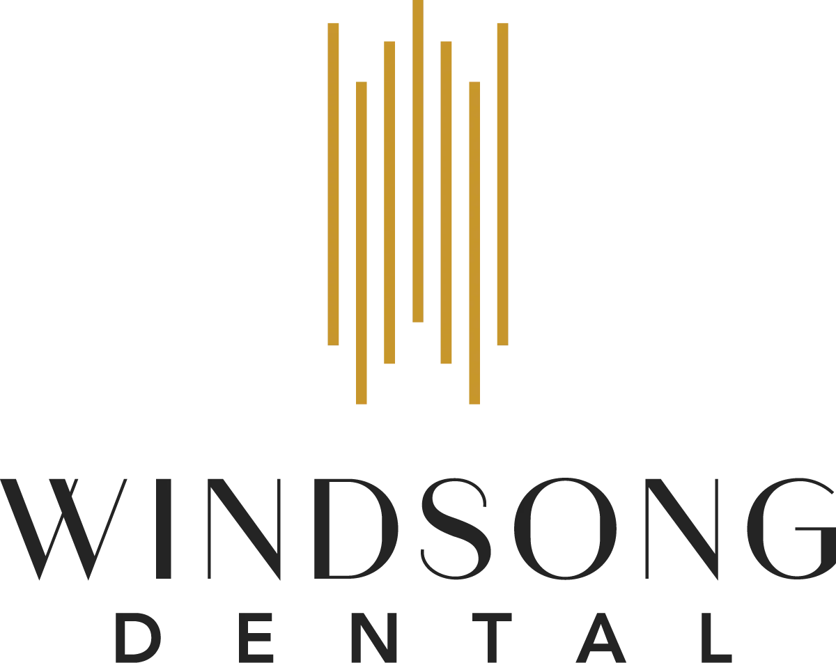 Logo of Windsong Dental featuring stylized gold lines above the text in matching gold typography on a white background.