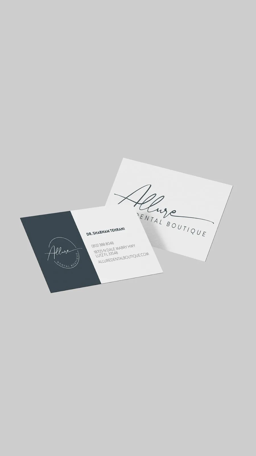 Two business cards for allure dental boutique featuring a minimalistic design with white and dark blue colors, showcasing logo and contact information.