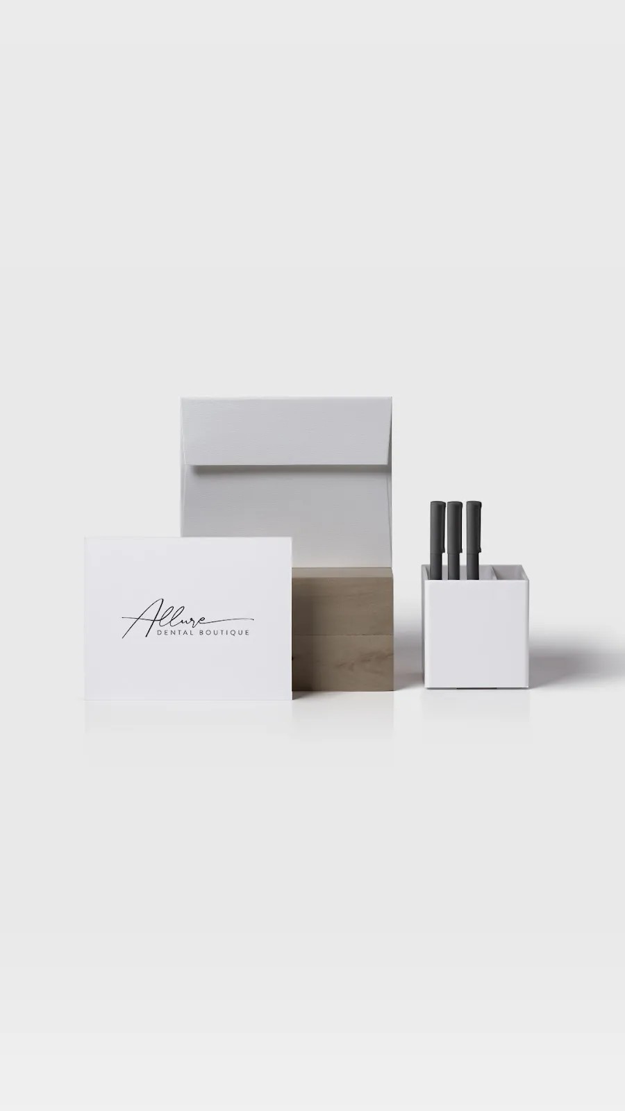 Minimalistic branding materials including business cards, boxes, and bottles on a white background.